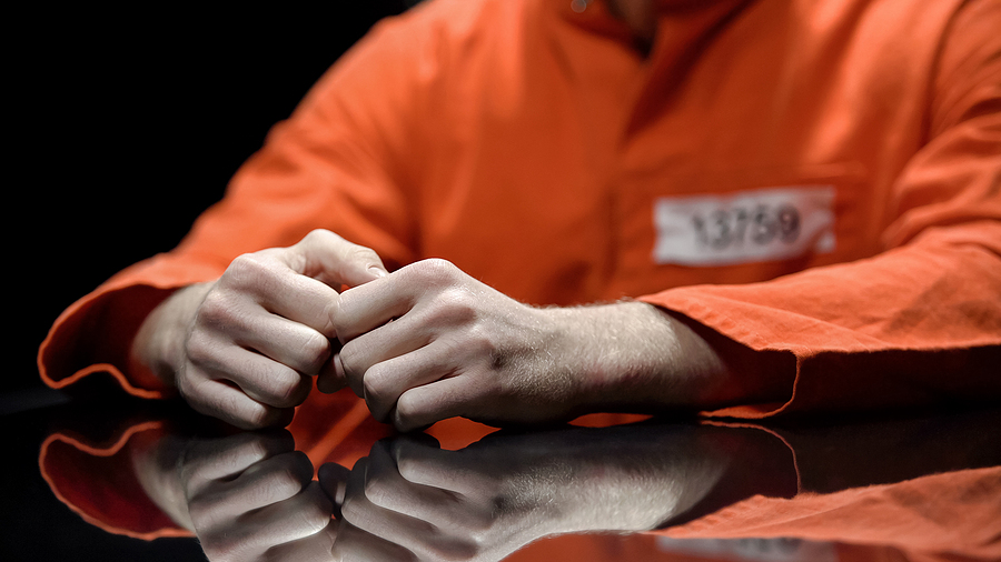 Arrested Person Hands Closeup, Prisoner Talking To Lawyer about federal criminal charges